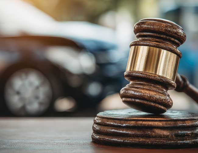 law gavel with car in background